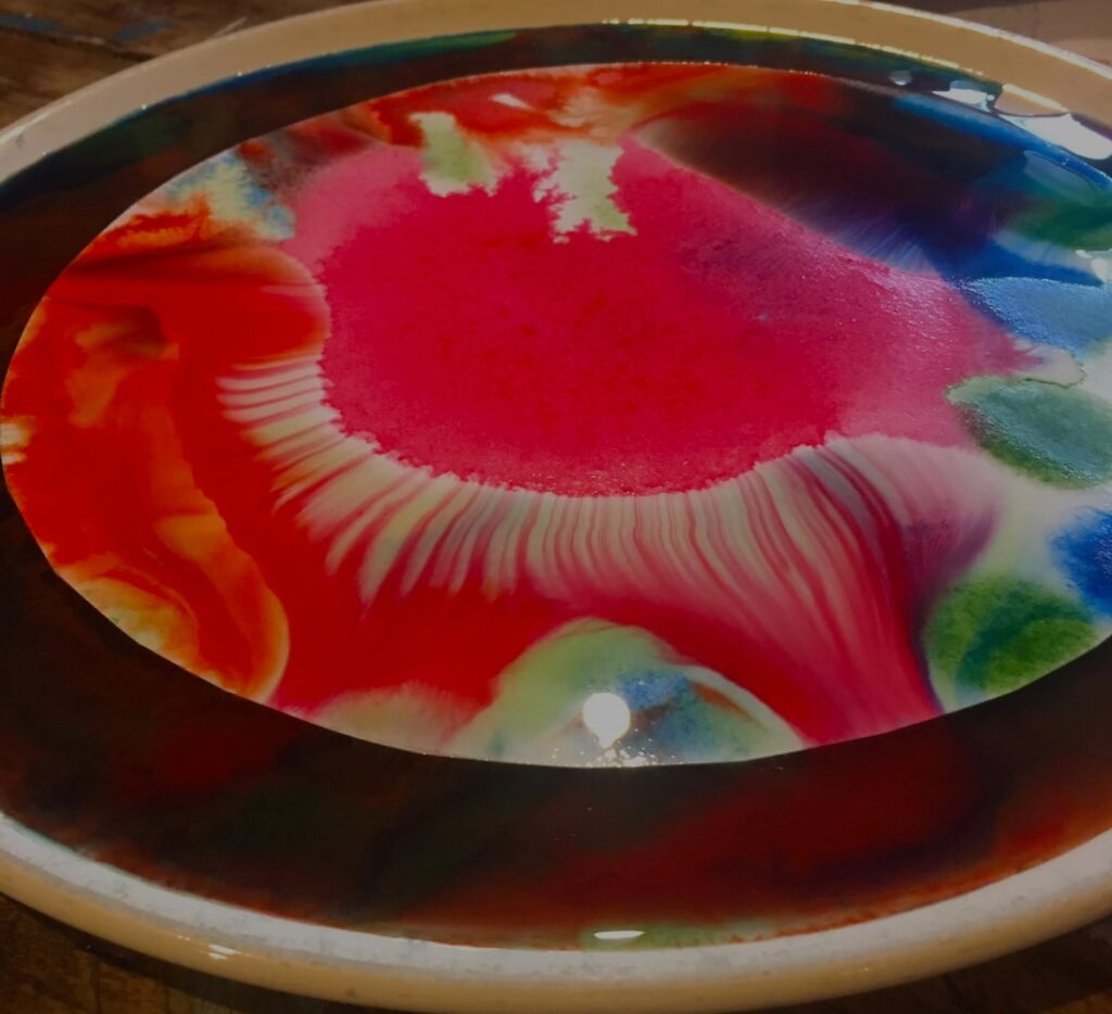 un mandala di colori in un piatto di acqua